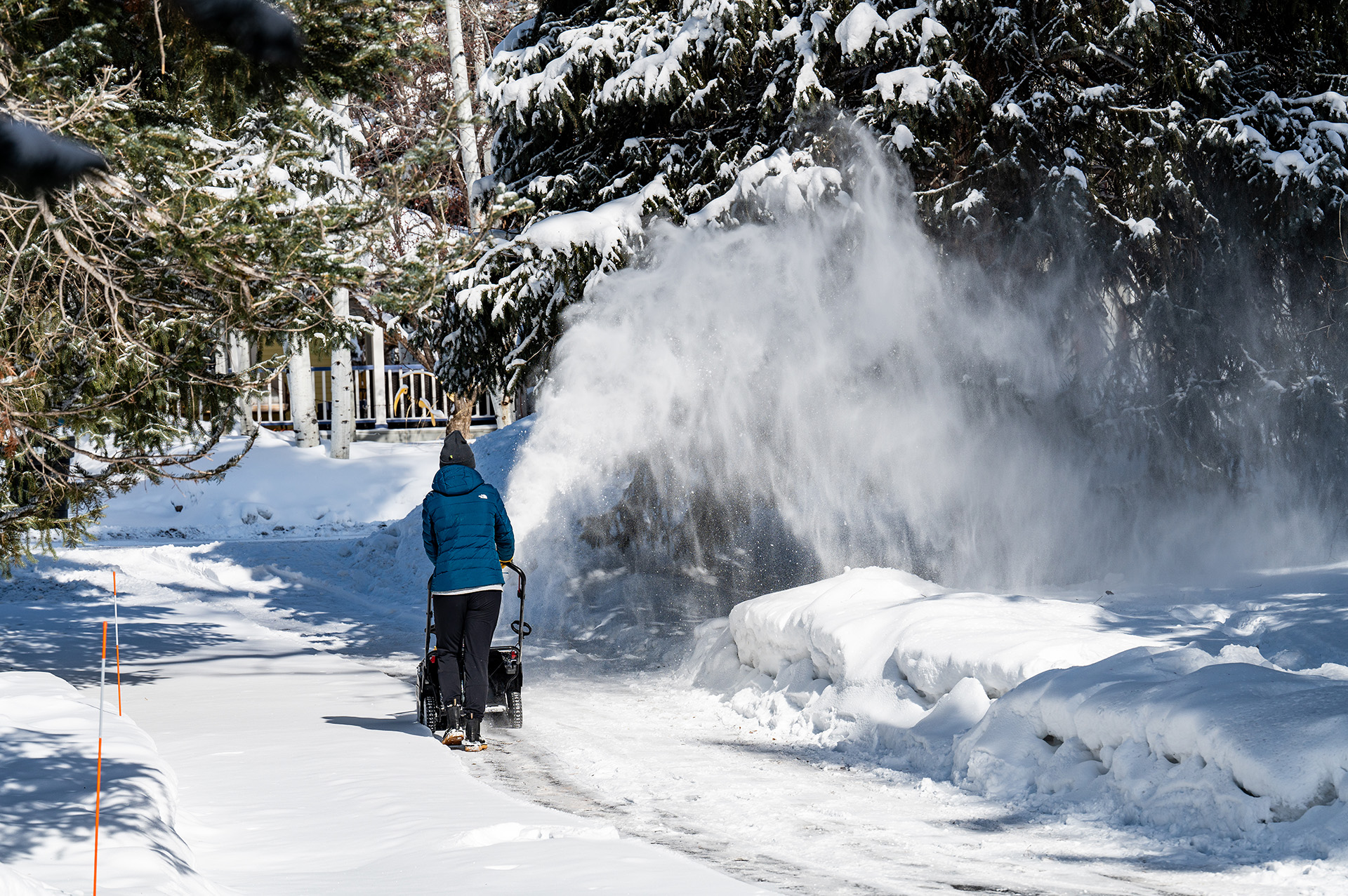 Person using Murray snow blower on driveway