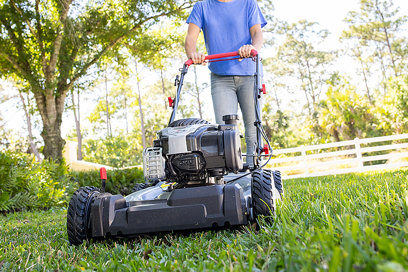 Woman mowing Murray self-propelled lawn mower