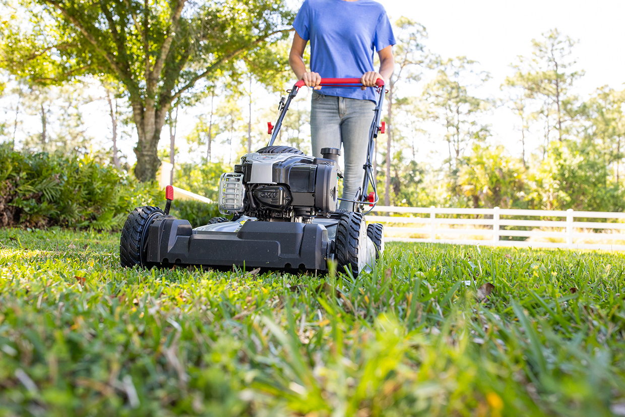 Woman mowing Murray self-propelled lawn mower