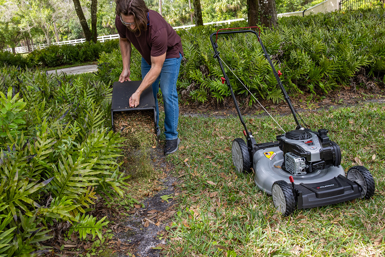 Man emptying Murray mower bagger full of grass clippings